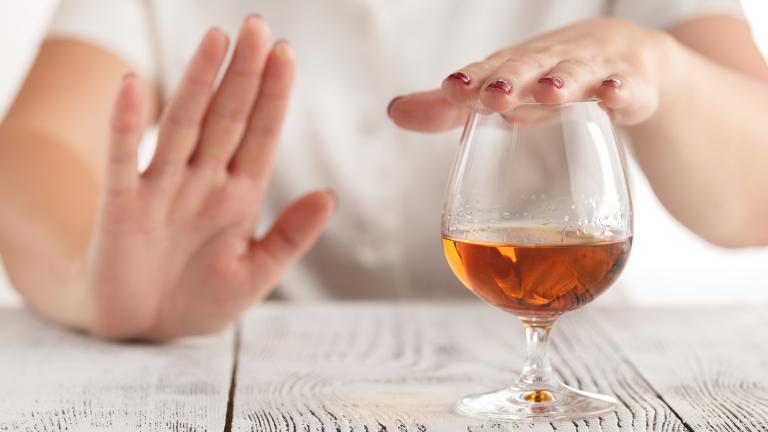 Woman refusing to top her drink up