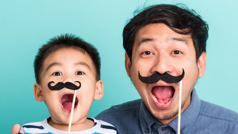 Man and child with false moustache