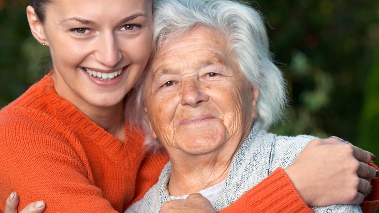 Young person hugging old person