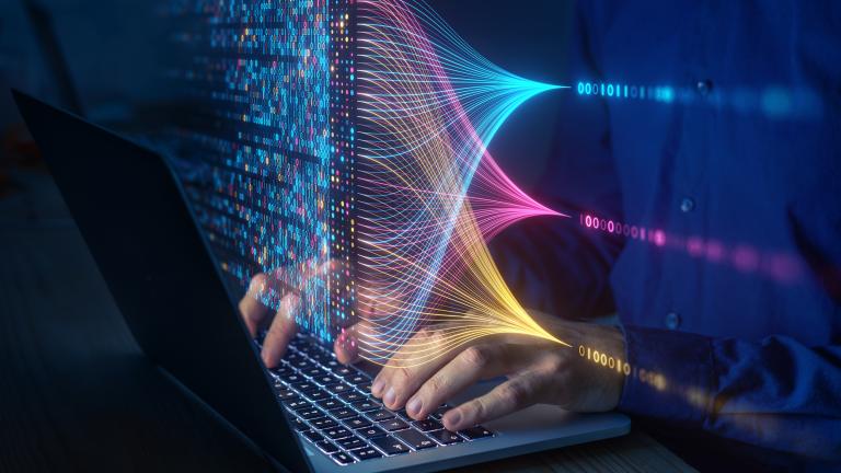 Hands typing on laptop with 0s and 1s