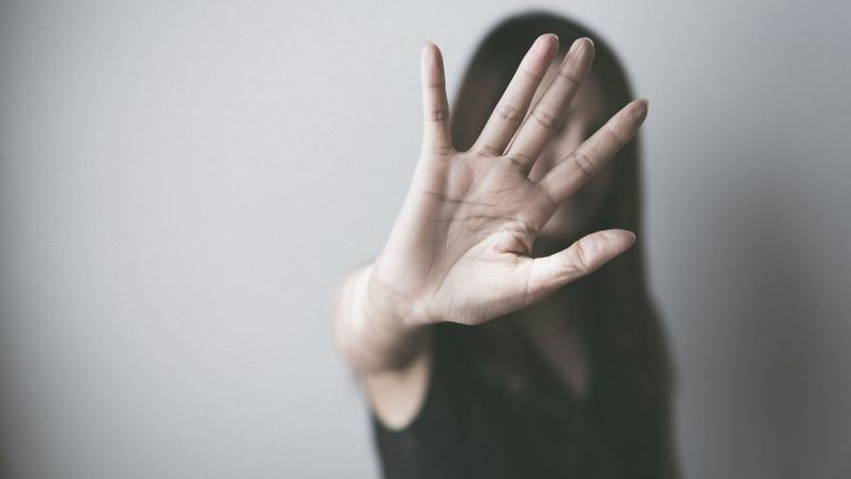 woman holding up palm