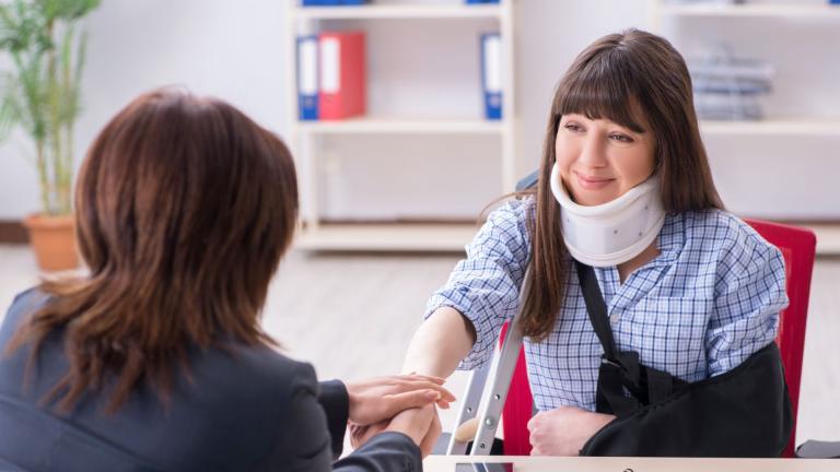 Woman with neckbrace shaking manager hands