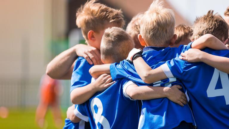 kids playing sport in a huddle