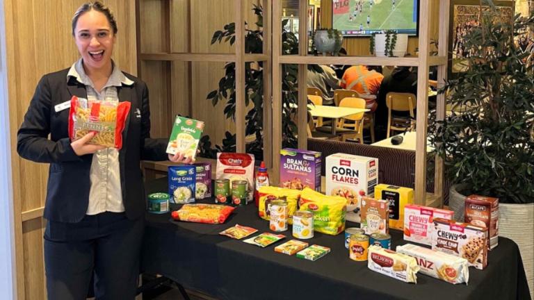 woman standing in front of table with groceries