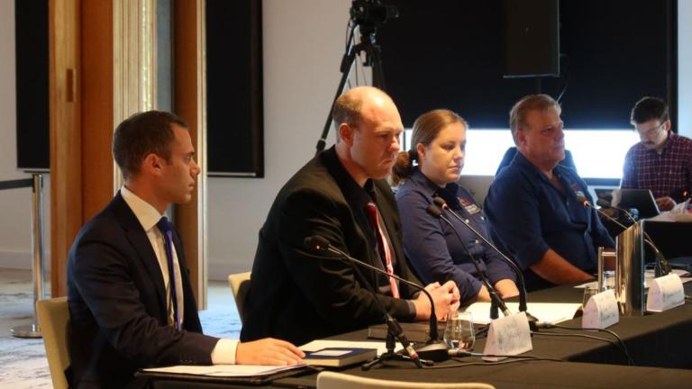 people seated with microphones