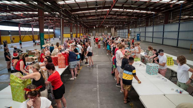 people in a warehouse packing boxes
