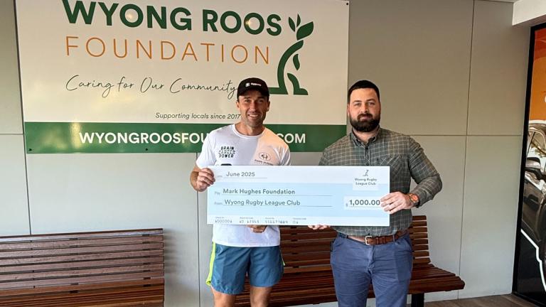two men holding a novelty cheque