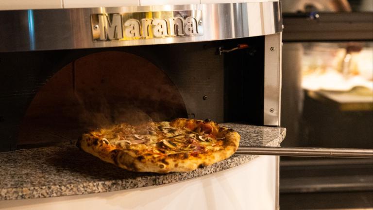 Morana pizza over with a pizza being cooked