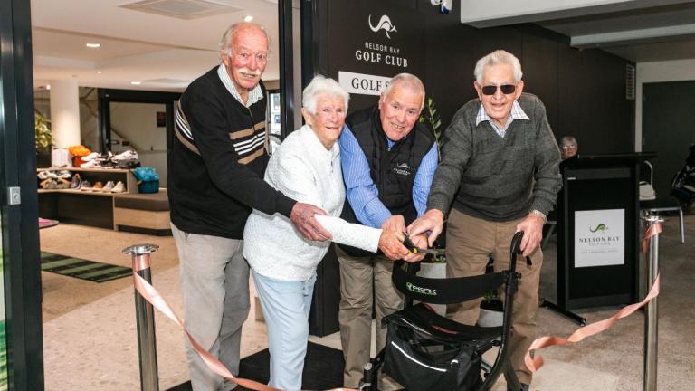 elderly people cutting ribbon