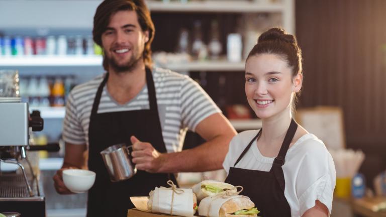 young baristas near coffee machine